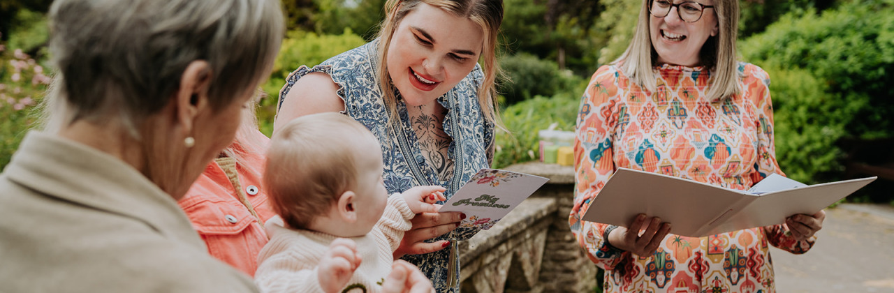 A photo of a naming ceremony taking place at The Temple of Minerva in Bath with Sam White Celebrant, a baby and his family.