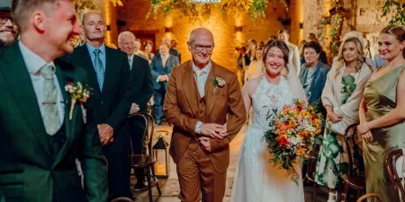A photo of a bride arriving with her Dad in the ceremonial space for a wedding ceremony with Sam White Celebrant at Cripps Barn.