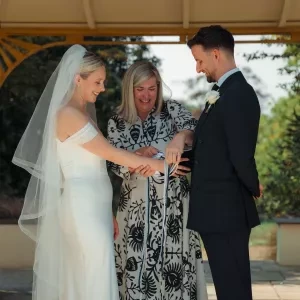 Sam White Celebrant forms the knot in a couple's handfasting ceremony.